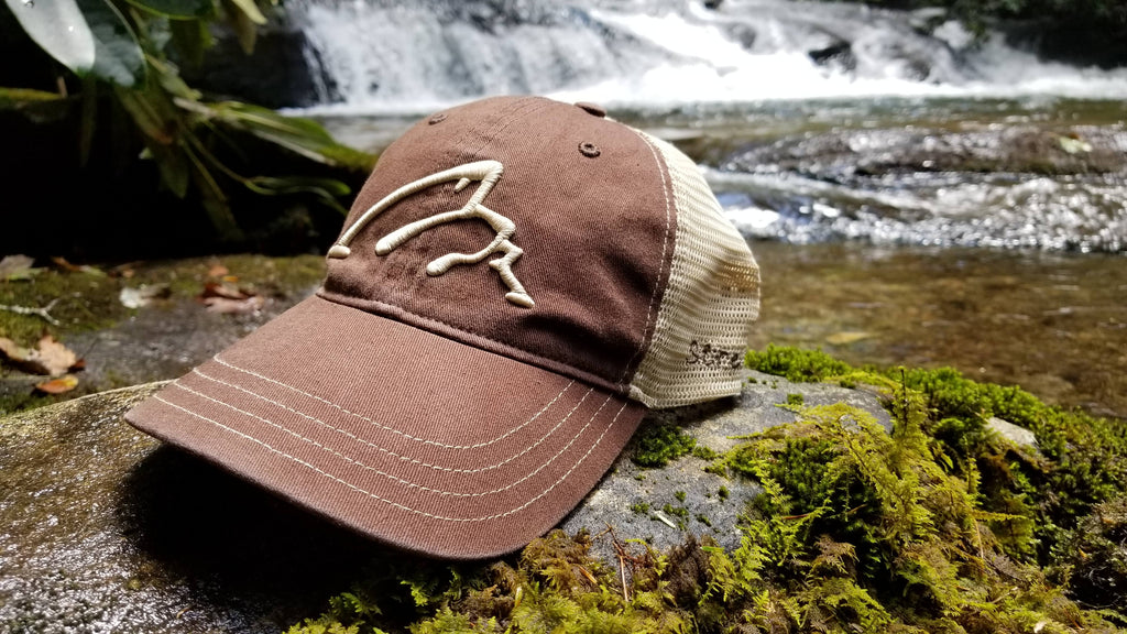 Fishing hat with logo from wild stream-bred rainbow trout caught in a mountain stream/river in the Chattahoochee National Forest while fly fishing in Blue Ridge, Georgia north of Atlanta, Georgia.